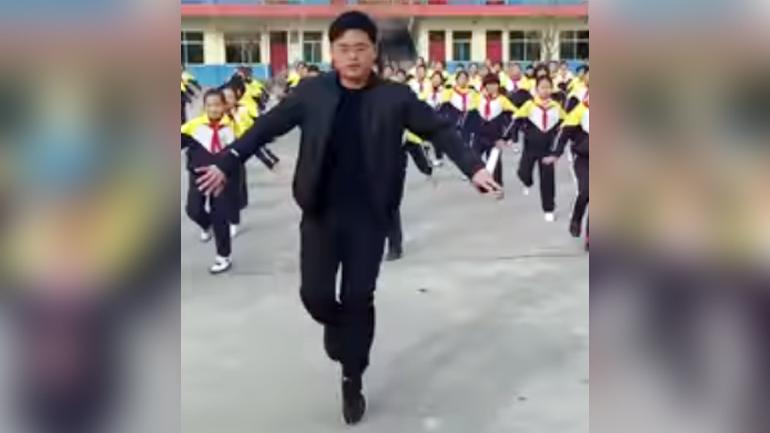 Chinese school principal performing a shuffle dance with his students has gone viral
