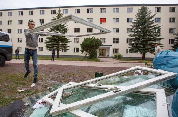 Frenzied riots in migrant camp after man tears up Koran and throws pages in TOILET