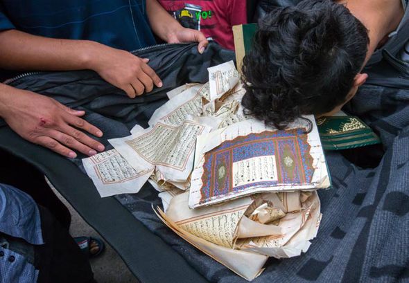 Frenzied riots in migrant camp after man tears up Koran and throws pages in TOILET