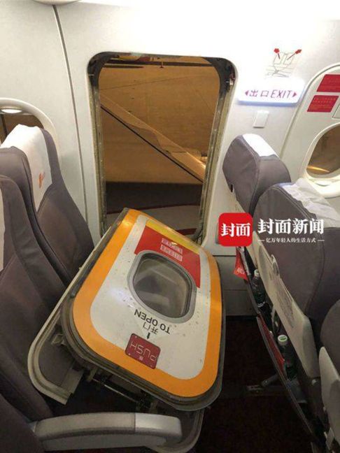 Chinese passenger pulls open escape hatch to get some fresh air while waiting